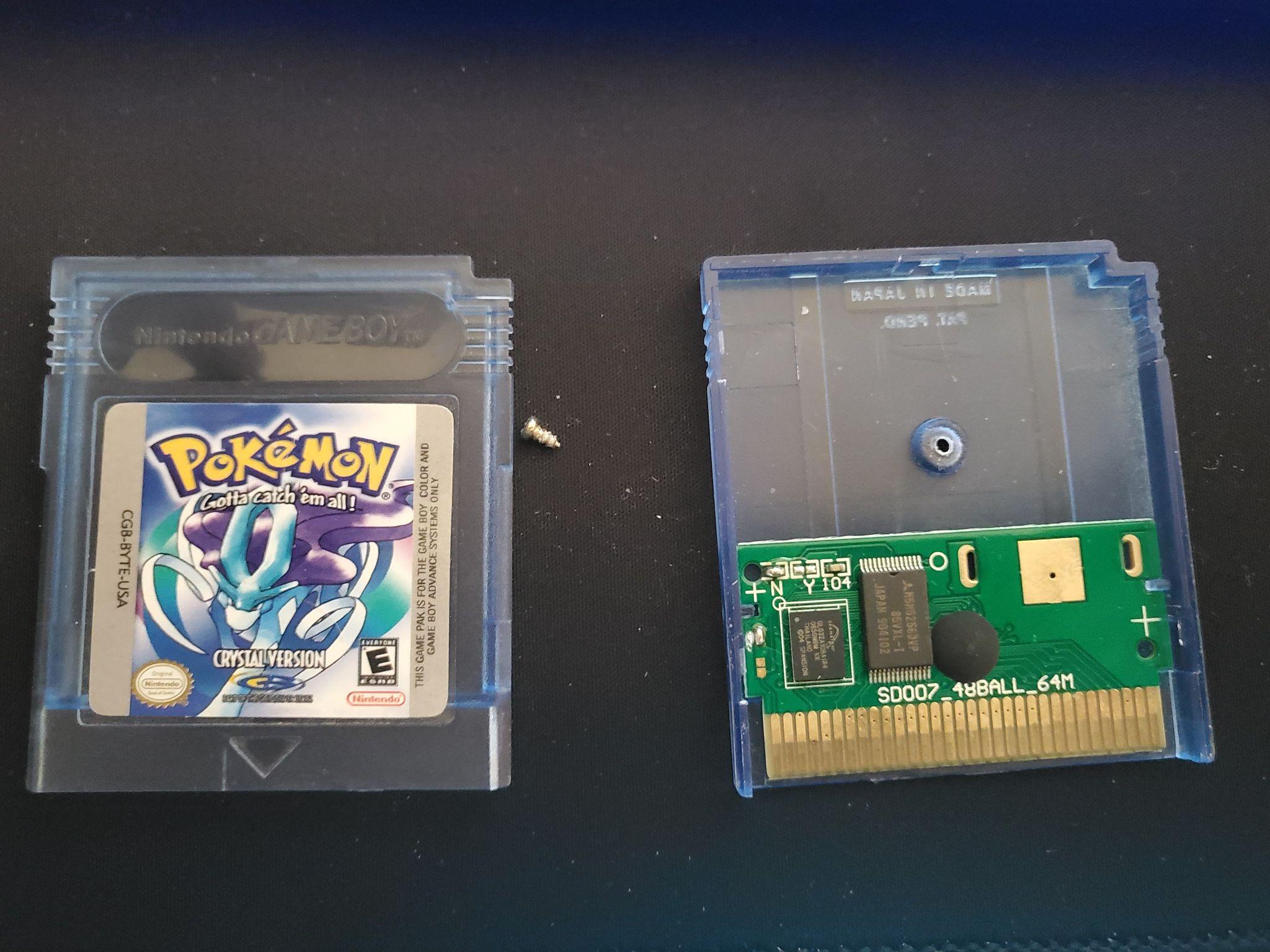 A Game Boy cartridge opened with the printed circuit board exposed.