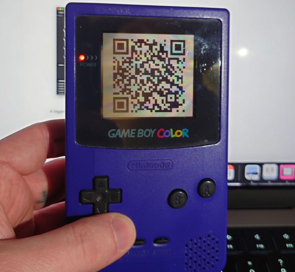 A photo of the QR code being displayed on an actual Gameboy.