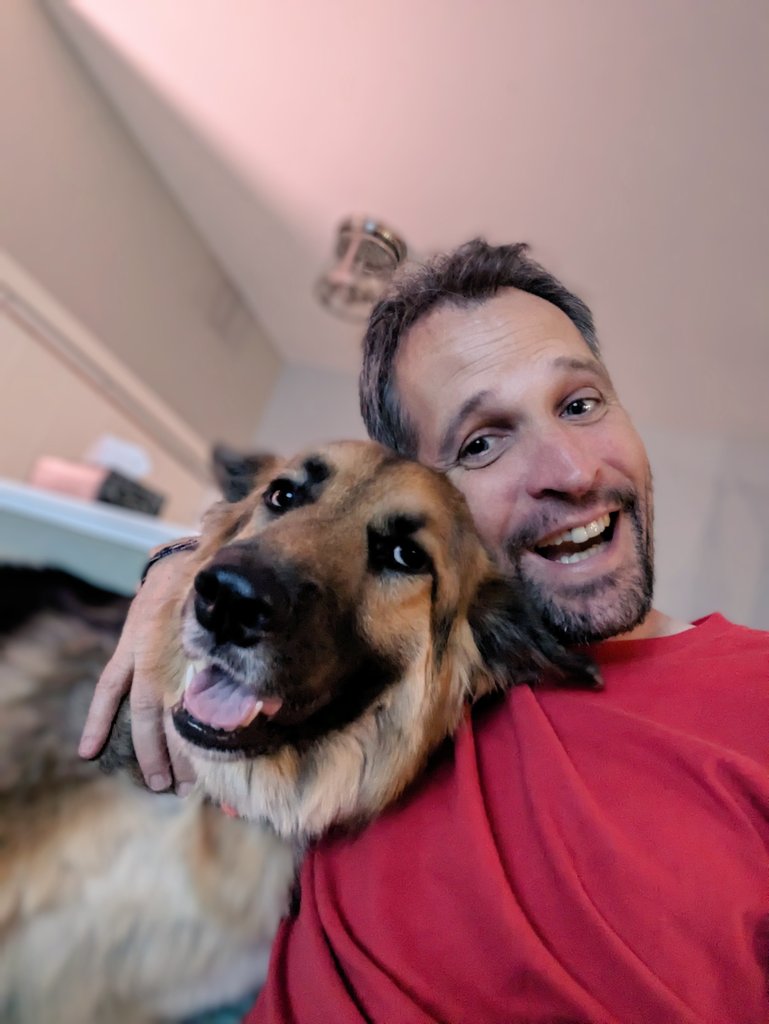 A photo of Shane and their dog.